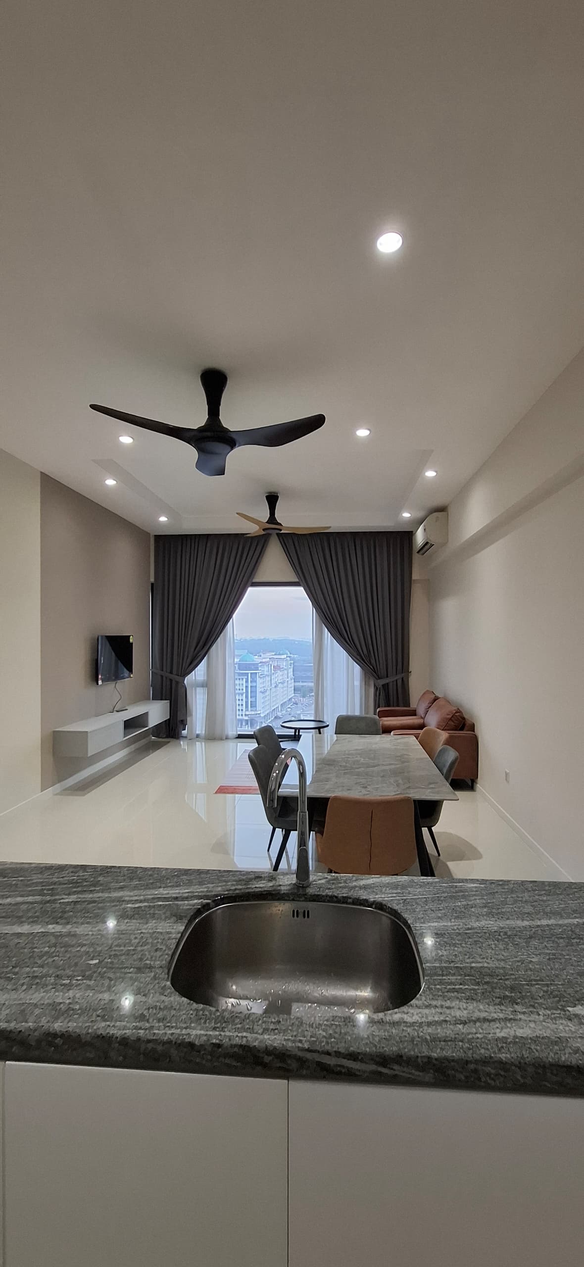 Open-plan kitchen and living renovation — marble countertop, city view
