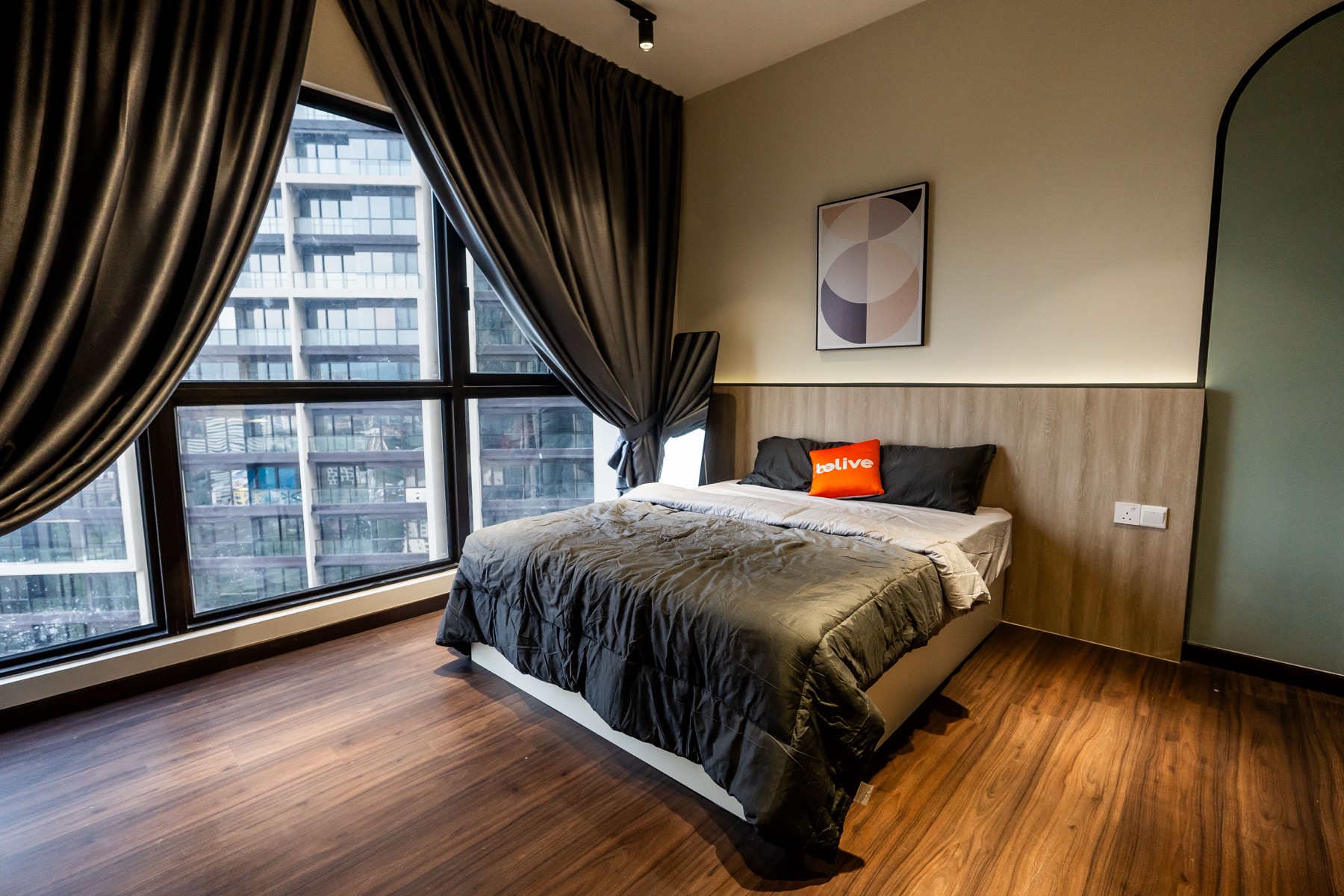 Duta Park master bedroom renovation — dramatic curtains, wooden flooring, city view