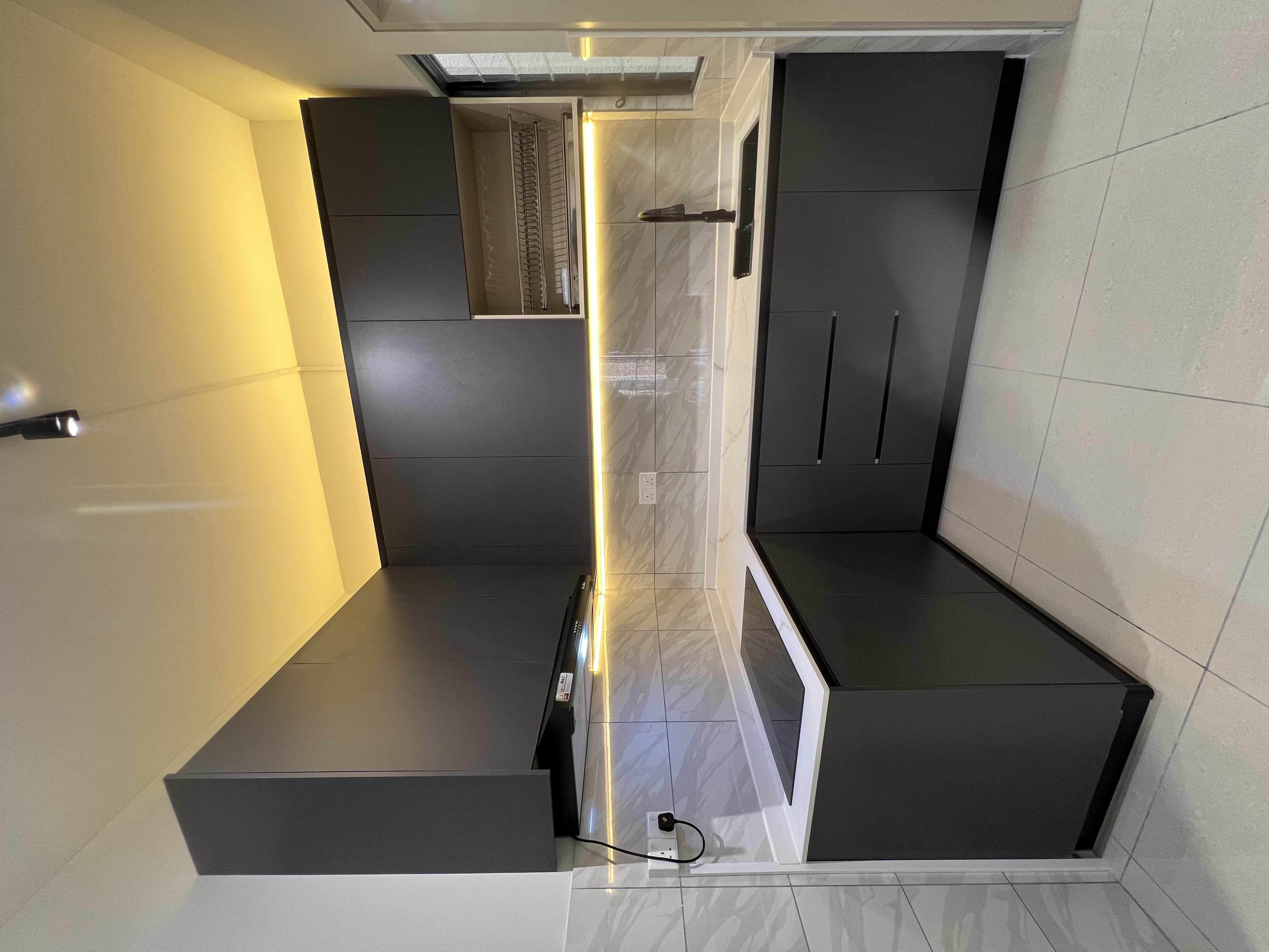 Black kitchen renovation — matte black cabinets, LED cove lighting