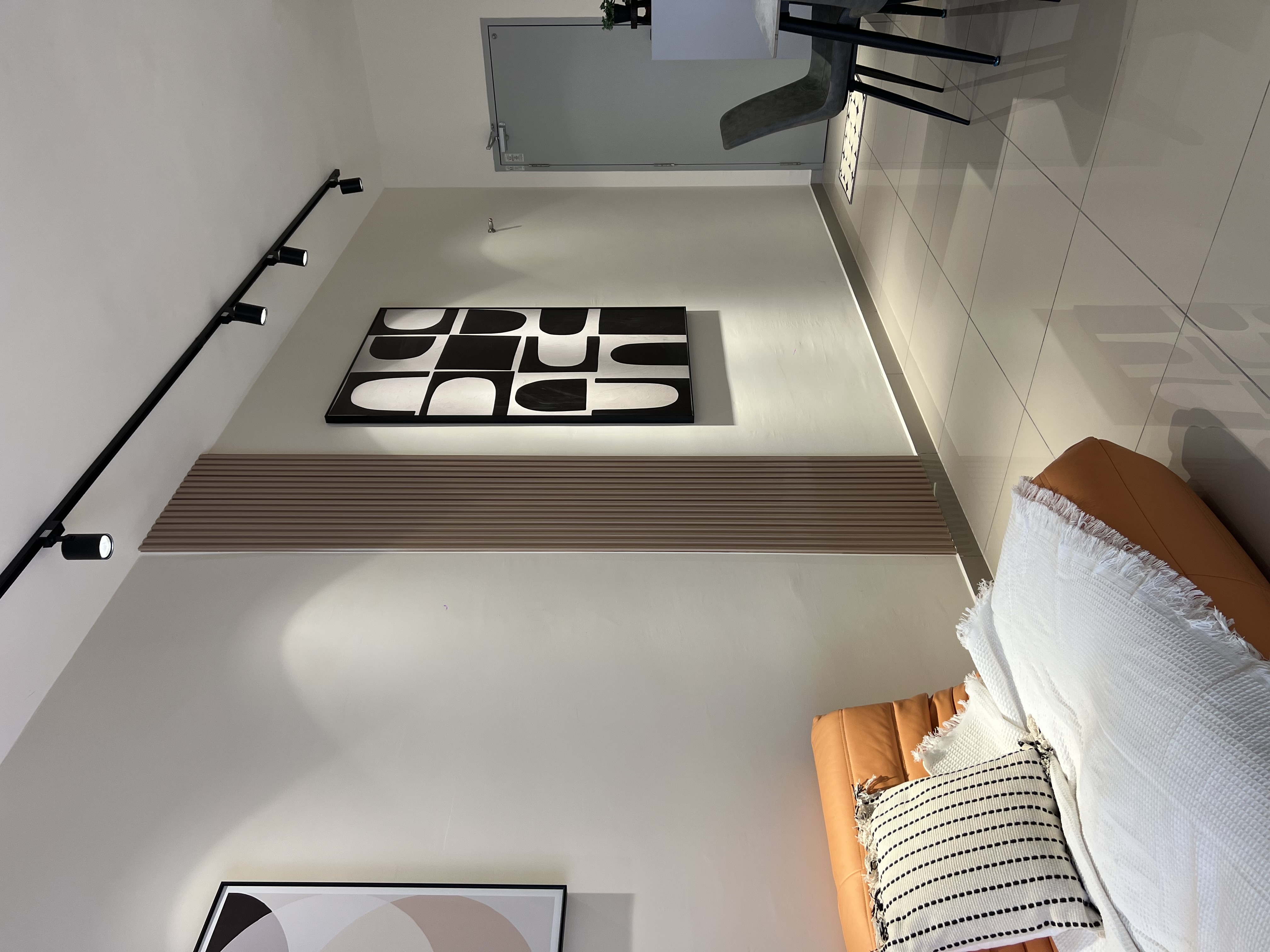 Living room — feature wall art, track lighting, open plan