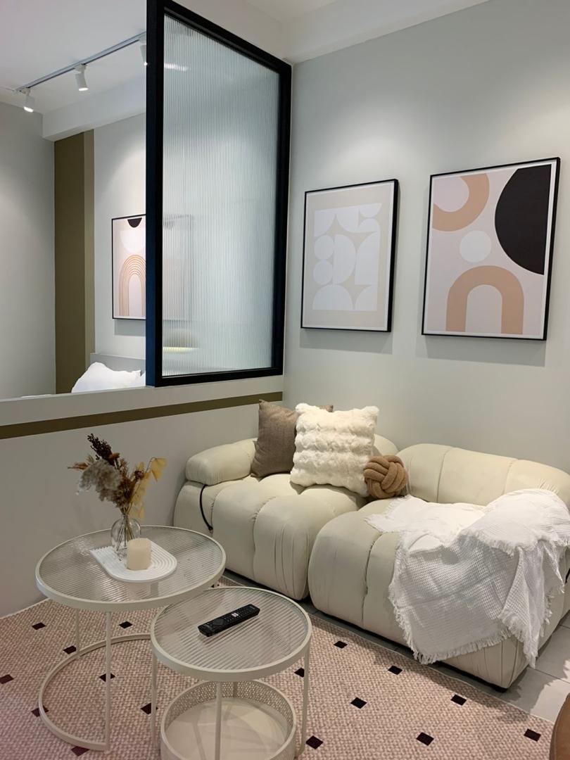 Living room — cream sofa, glass partition, art wall